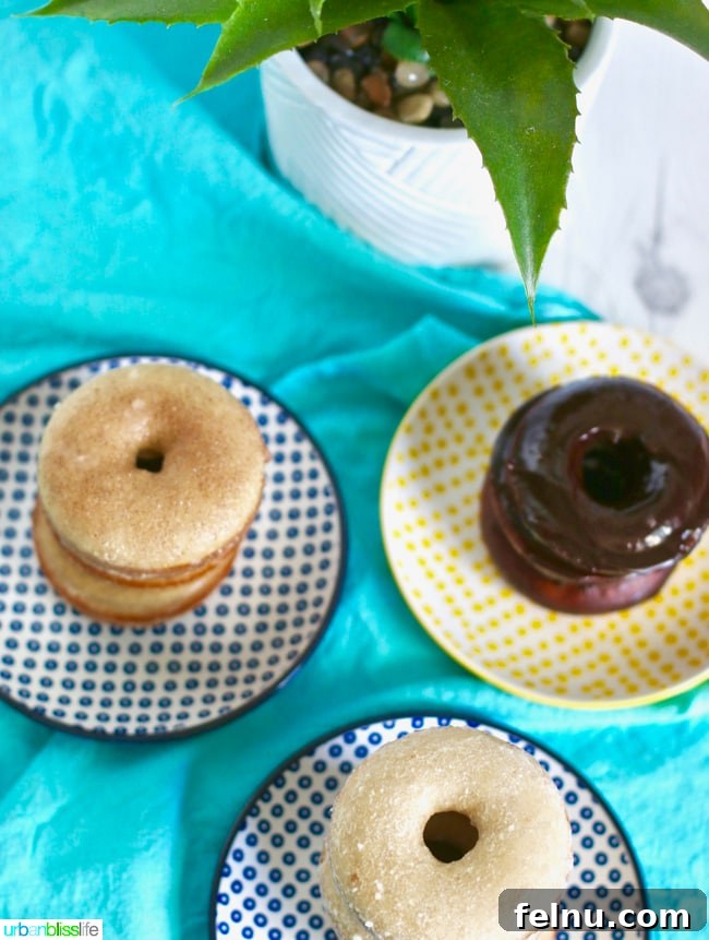 A close-up of Baked Cinnamon Sugar Donuts with Three Glazes stacked, highlighting the textures and flavors.