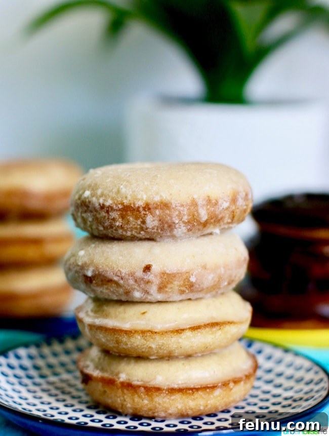 A stack of freshly baked cinnamon sugar donuts, glazed and ready to be devoured.