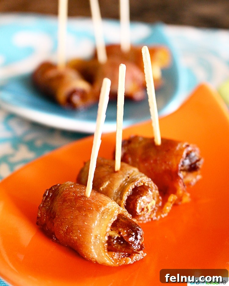 Smoky Bacon-Wrapped Dates with Creamy Goat Cheese 2 Bacon-Wrapped Dates Stuffed with Goat Cheese on a serving plate, perfect party appetizer.