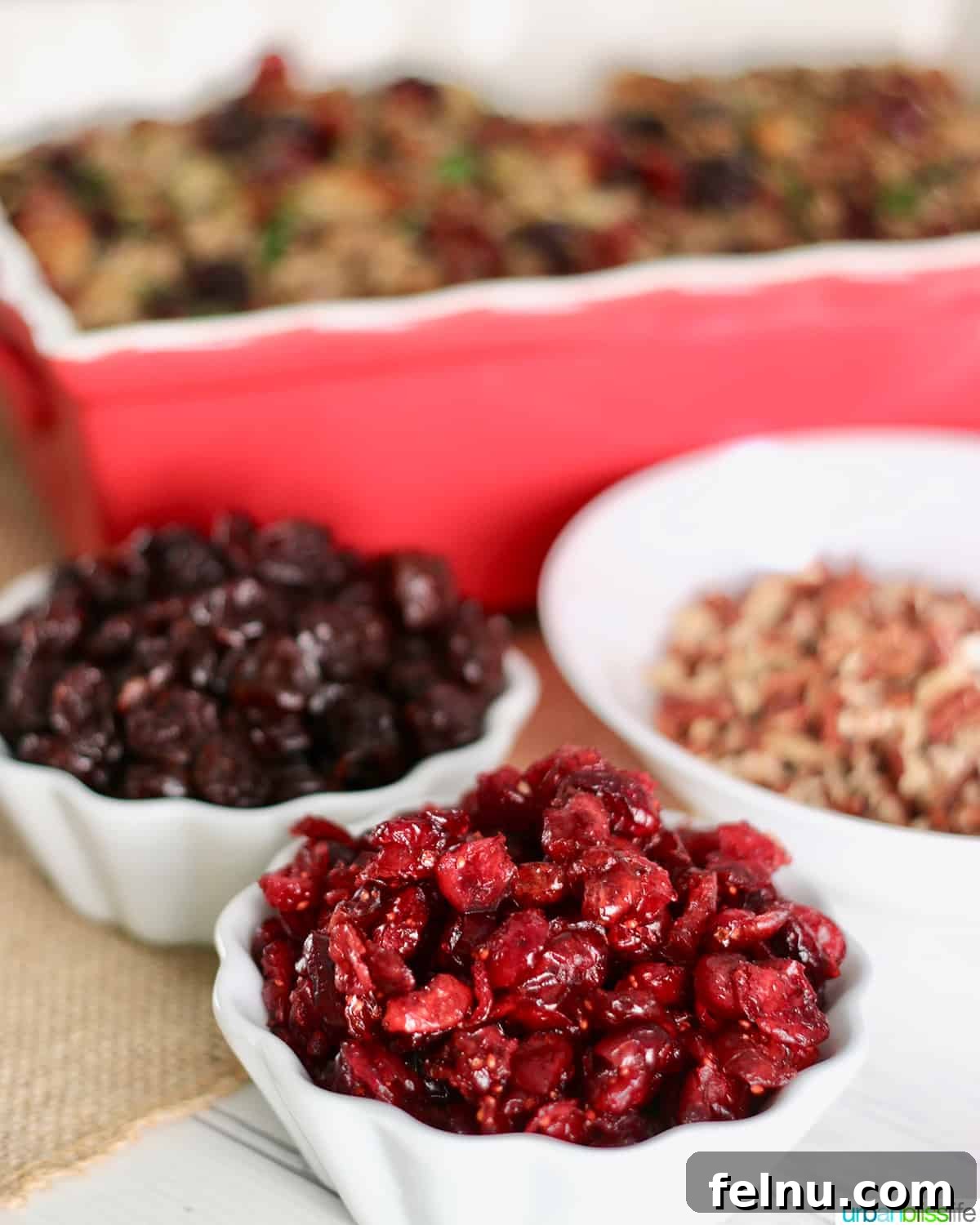 A Festive Harvest Stuffing 4 Bowls of cranberries and cherries next to thanksgiving stuffing