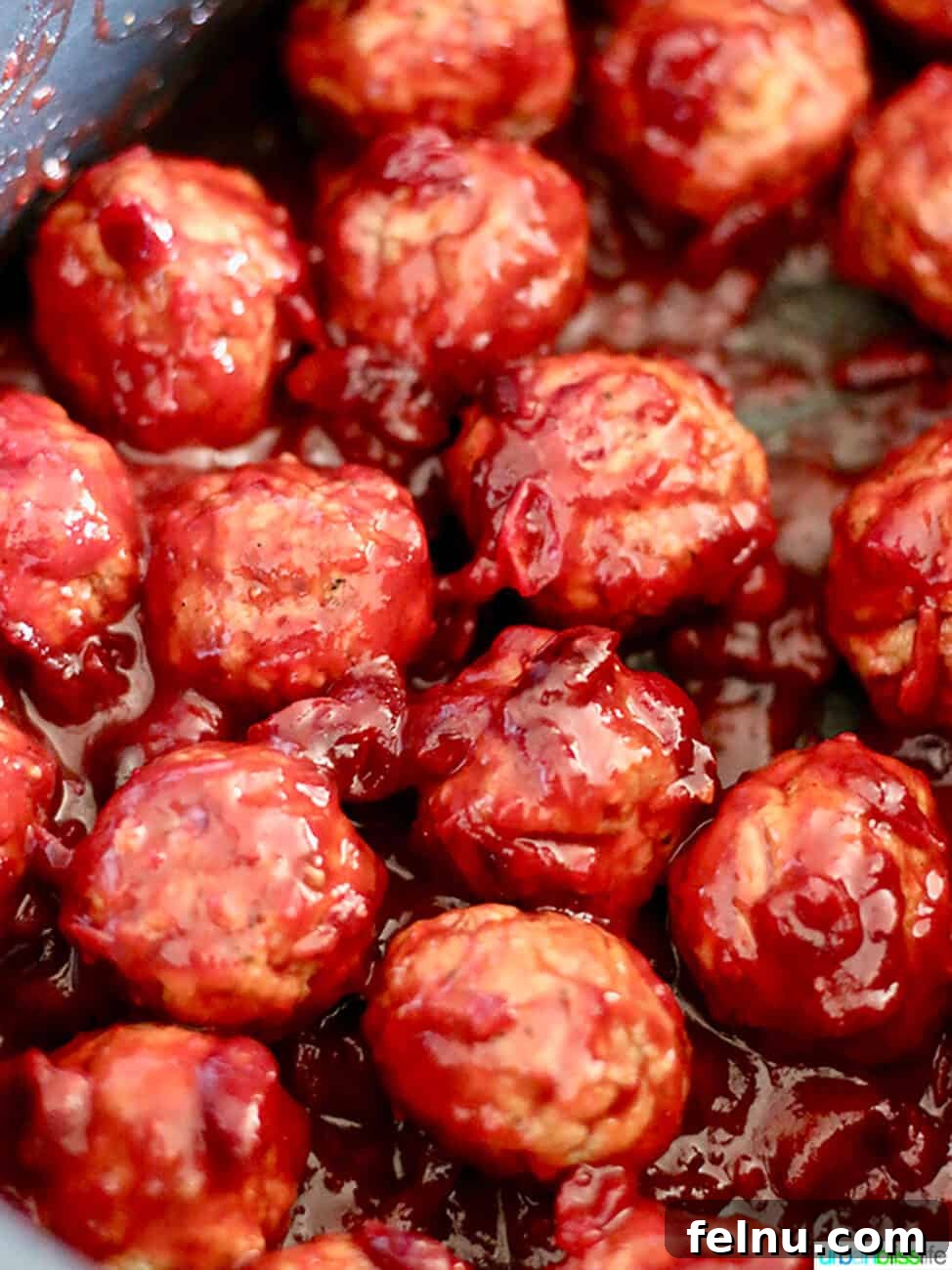Sweet and Tangy Cranberry Glazed Meatballs 10 cranberry meatballs simmering in a slow cooker