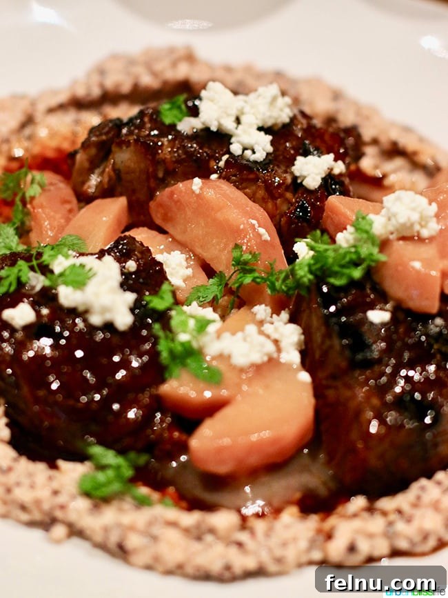 Tanner Creek Tavern: Pearl District Urban Hearth 13 Braised Lamb Shank with poached quince and black corn polenta at Tanner Creek Tavern, a hearty and flavorful meat dish.