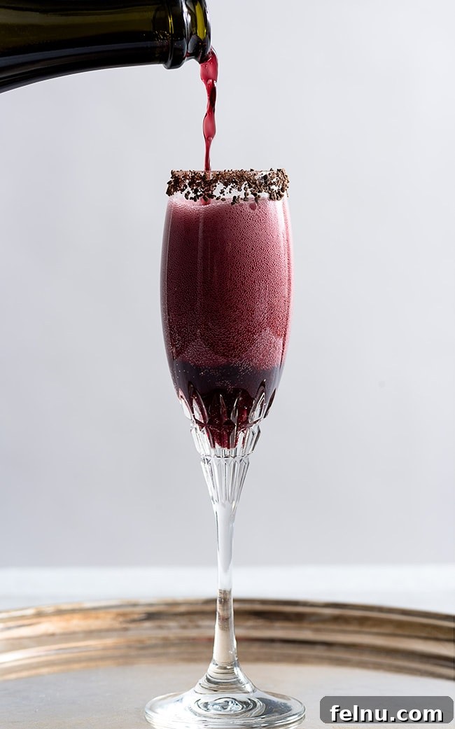 Festive Winter Sips: 20 Cocktail Recipes for Your Holiday Gathering 8 Sparkling Shiraz Cocktail with dark chocolate coated cacao nibs, an elegant winter drink.