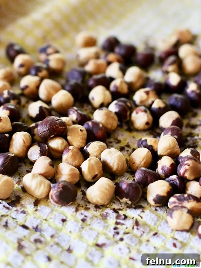 Homemade Nutella: A Decadent Chocolate Hazelnut Dream 5 Roasted Hazelnuts on a Baking Sheet