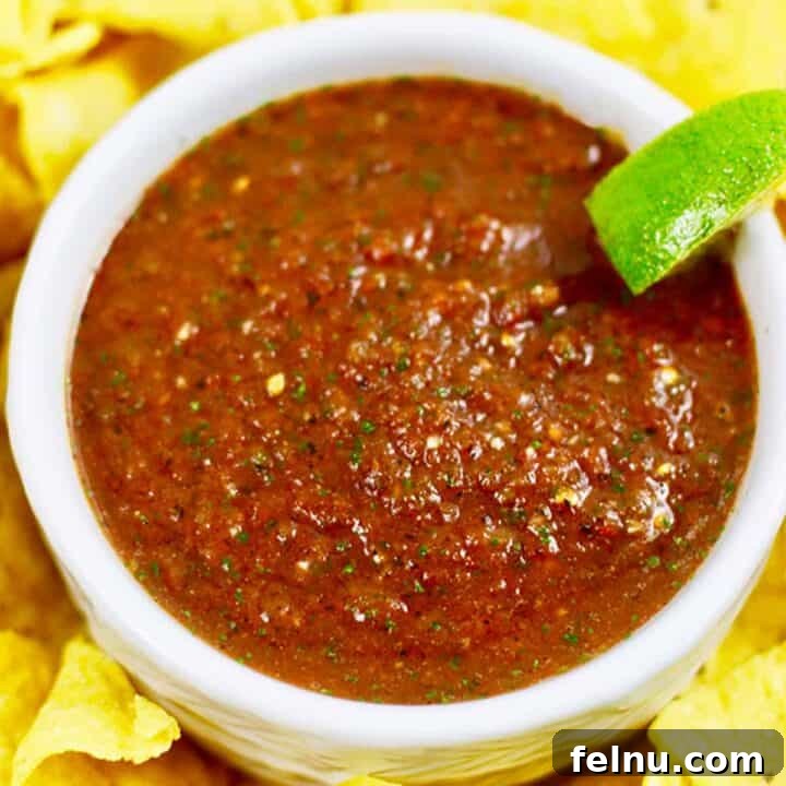 Homemade restaurant-style salsa in a bowl with lime.