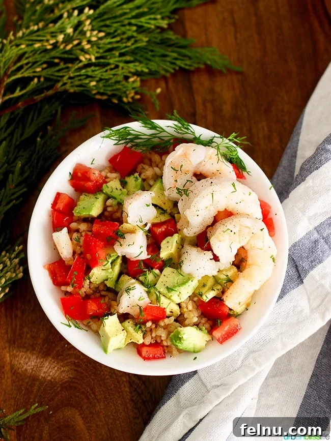 Shrimp Avocado Brown Rice Bowl garnished with fresh dill on UrbanBlissLife.com