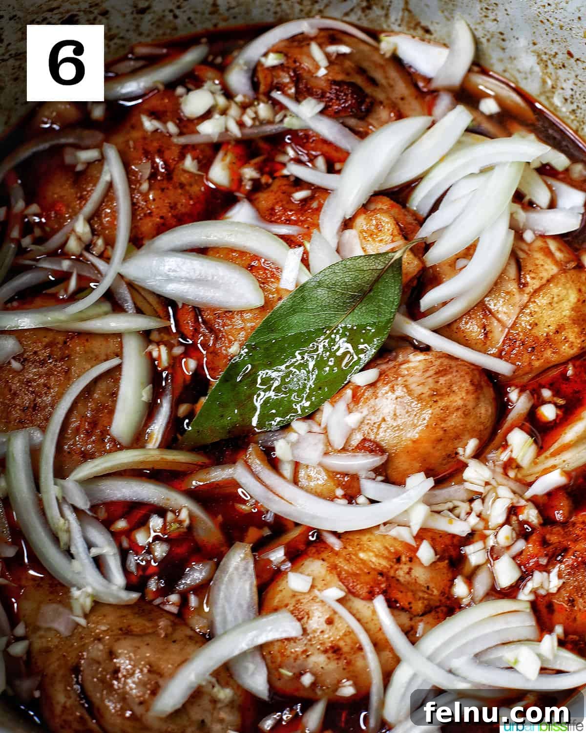 Ultimate Instant Pot Chicken Adobo 11 bay leaves, garlic, onions, soy sauce, sugar added to chicken adobo in the Instant Pot.