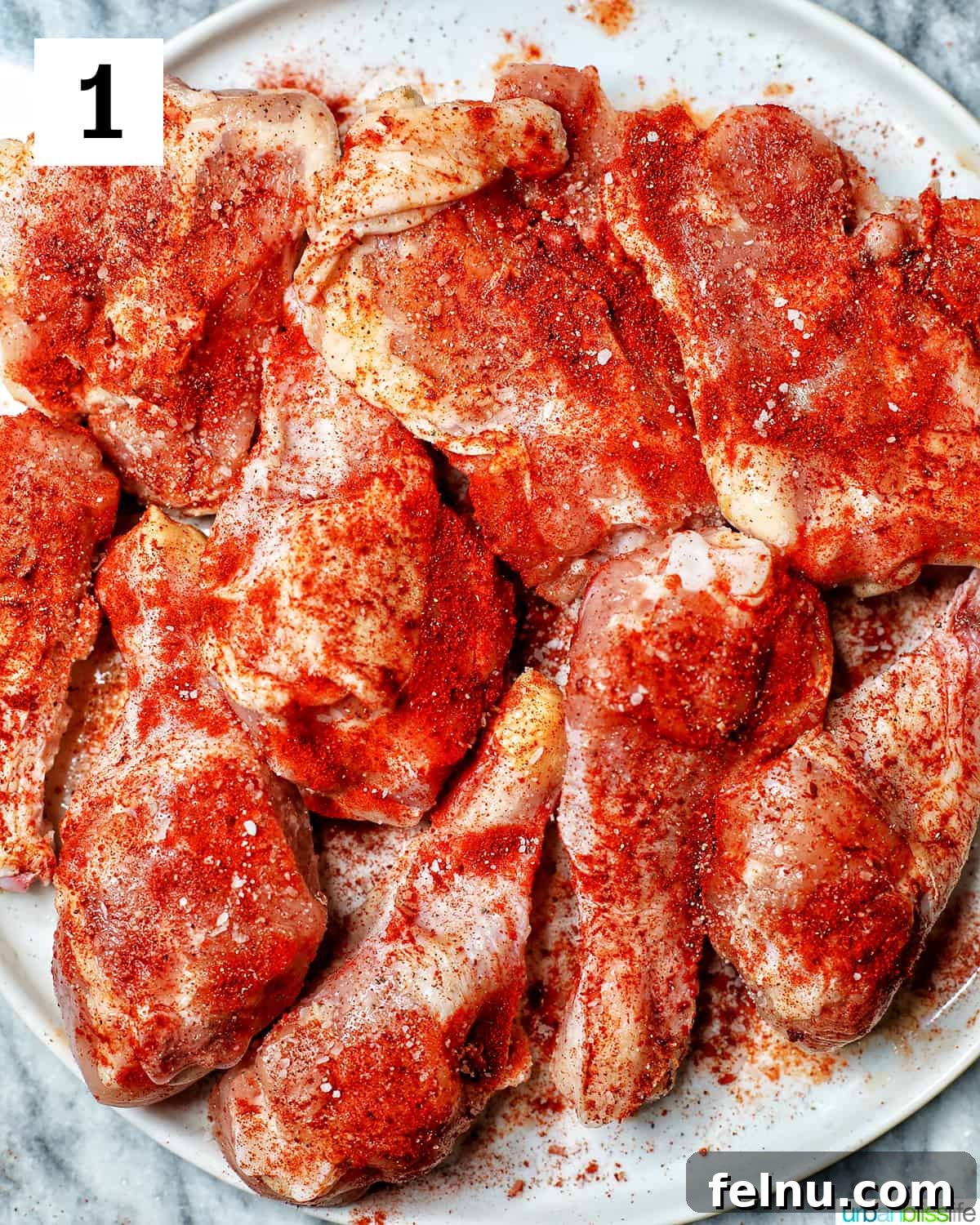 Ultimate Instant Pot Chicken Adobo 5 plate with chicken pieces seasoned with paprika, salt, and pepper.