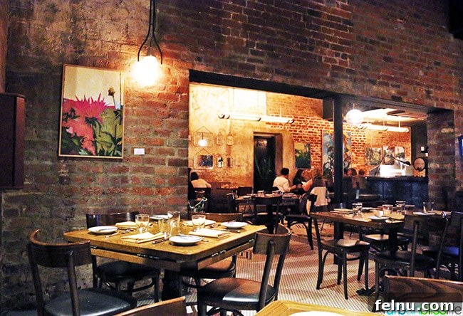 Where Caribbean Spice Meets Creole Soul at Compère Lapin New Orleans 4 Restaurant interior of Compere Lapin with modern decor and lighting.