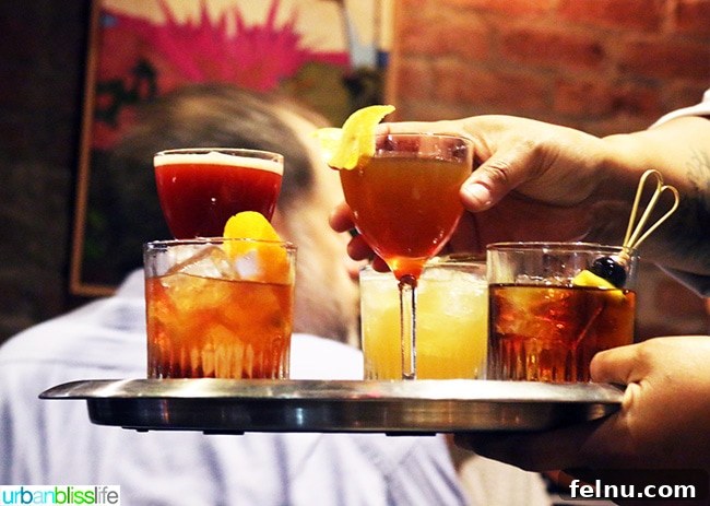Where Caribbean Spice Meets Creole Soul at Compère Lapin New Orleans 6 Two exquisitely crafted cocktails served on a small platter.