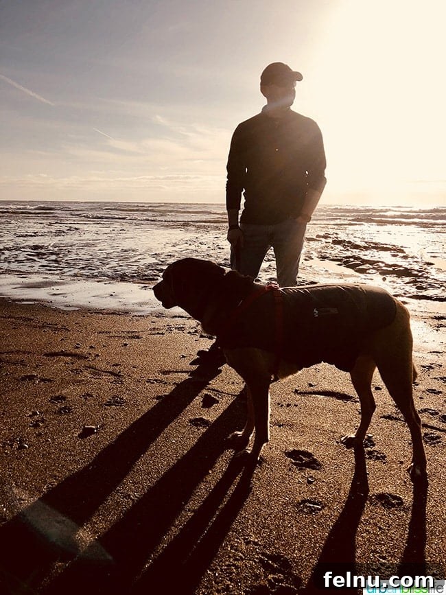 Alain and Kirby, the family dog, watching the sunset on Lincoln City beach.