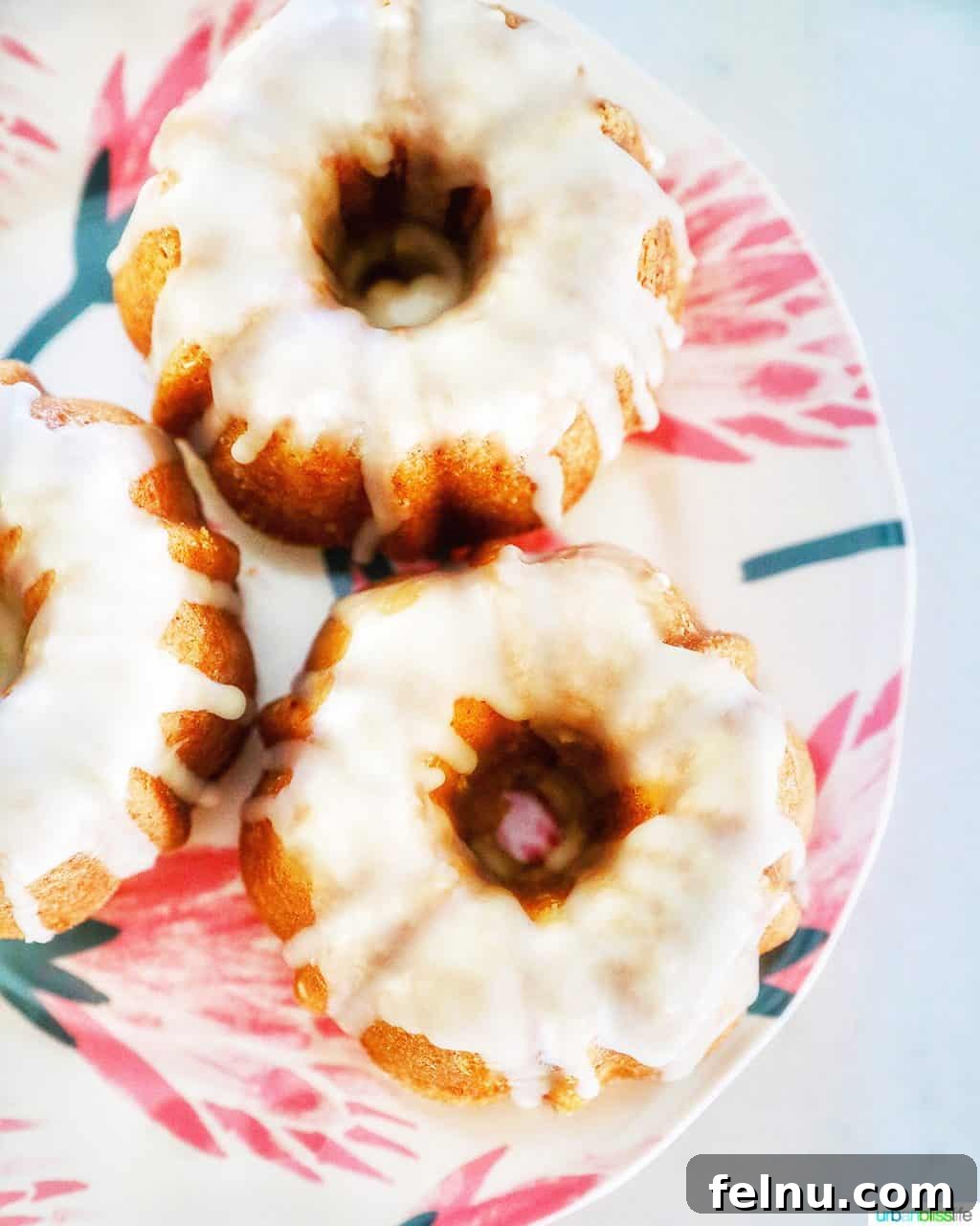Citrus Kissed Mini Bundt Cakes 2 Plate of three mini citrus bundt cakes, garnished with orange slices