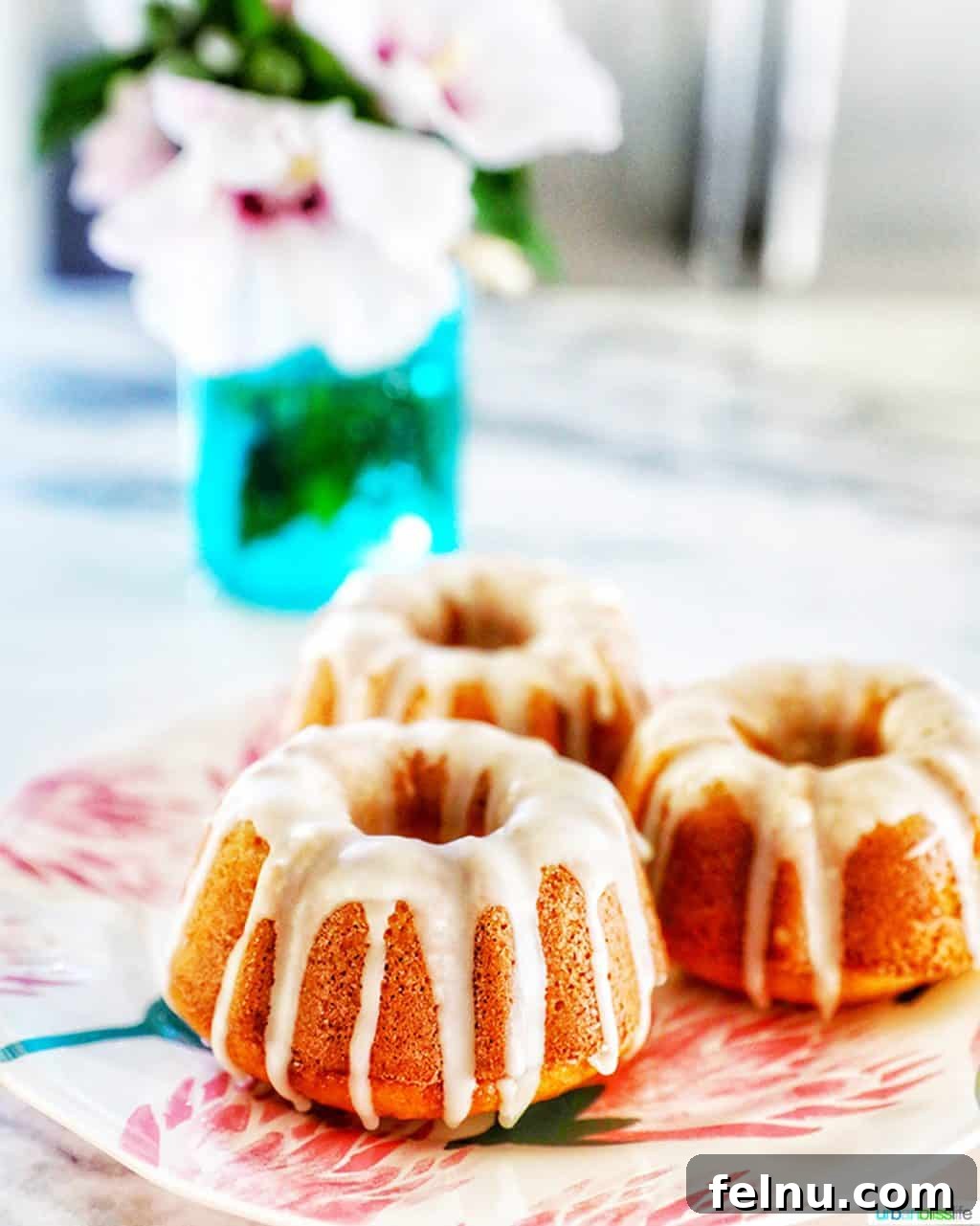 Citrus Kissed Mini Bundt Cakes 3 Close-up, straight-on view of three mini bundt cakes with fresh citrus slices