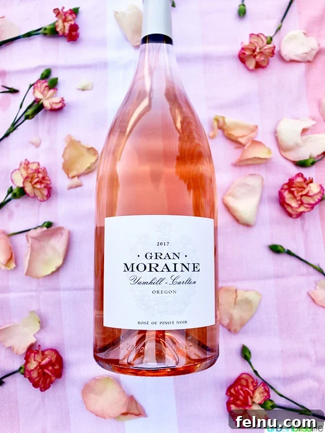 Rose Renaissance: Must-Try Wines for Every Palate 4 Gran Moraine 2017 Rosé of Pinot Noir with a floral backdrop, emphasizing its delicate nature.