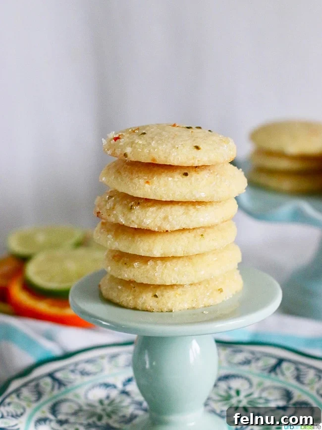 Triple Citrus Sugar Cookies 2 Stacked lemon sugar cookies with fresh lemons, perfect for summer snacking.