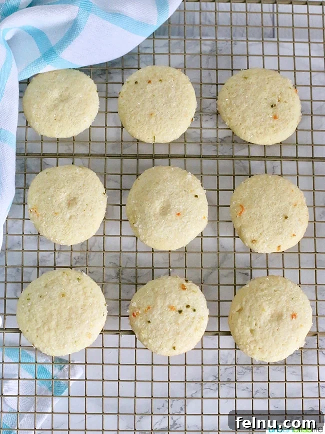 Triple Citrus Sugar Cookies 6 Freshly baked lemon sugar cookies cooling on a wire rack.