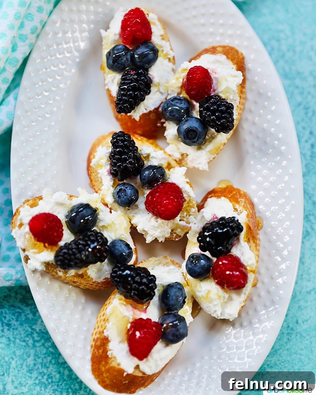 Ricotta Crostini Topped with Summer Berries and Honey Drizzle 3 Plate of ricotta crostini with summer berries