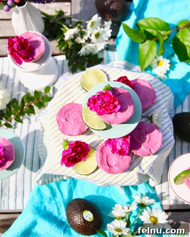 Flatlay of the layered vegan cheesecakes showing the avocado, lime, and pink pitaya layers