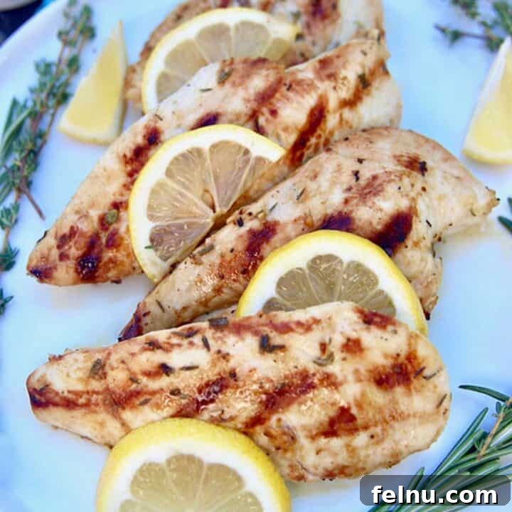 Lemon grilled chicken with herbs on a platter.