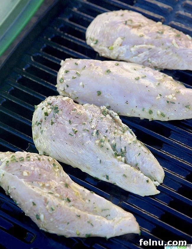 Zesty Lemon Pepper Grilled Chicken 6 Lemon pepper chicken breasts cooking on a hot grill with visible grill marks.