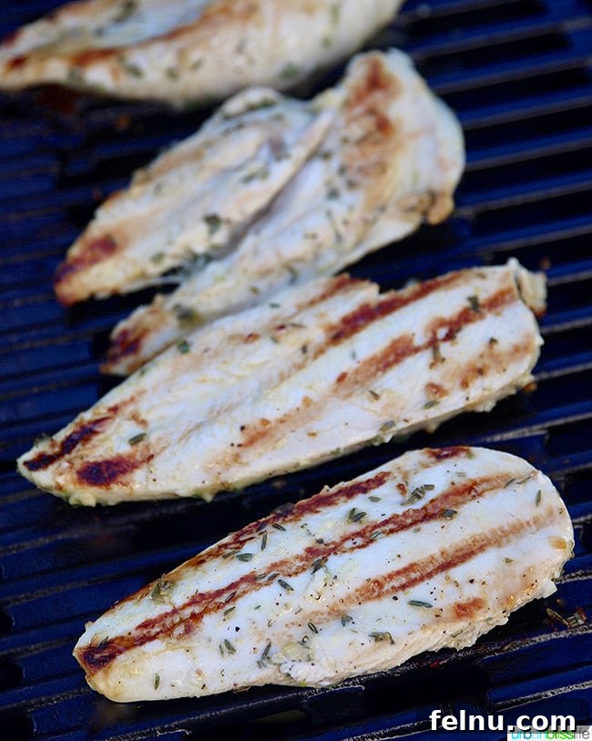 Zesty Lemon Pepper Grilled Chicken 7 Grilled lemon pepper chicken breasts resting on the grill before being removed.