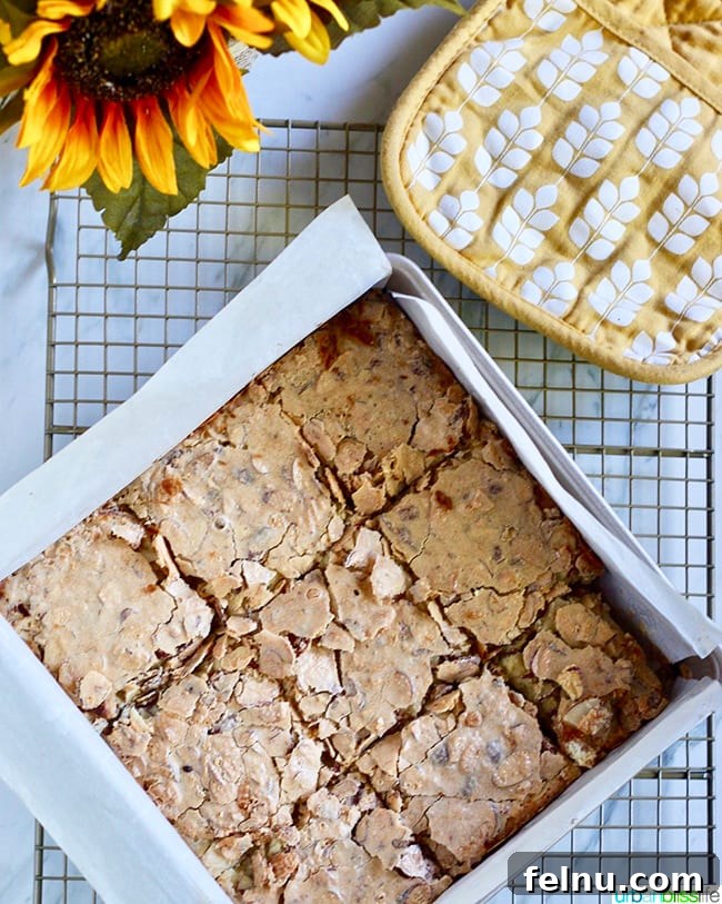 Almond Swedish Visiting Cake Bars 2 Delicious Swedish Visiting Cake Bars, freshly sliced in a baking pan, showcasing their golden-brown topping and tender interior.
