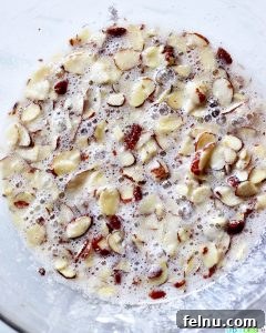 Almond Swedish Visiting Cake Bars 10 Mixing the almond and egg white topping for Swedish Visiting Cake Bars.