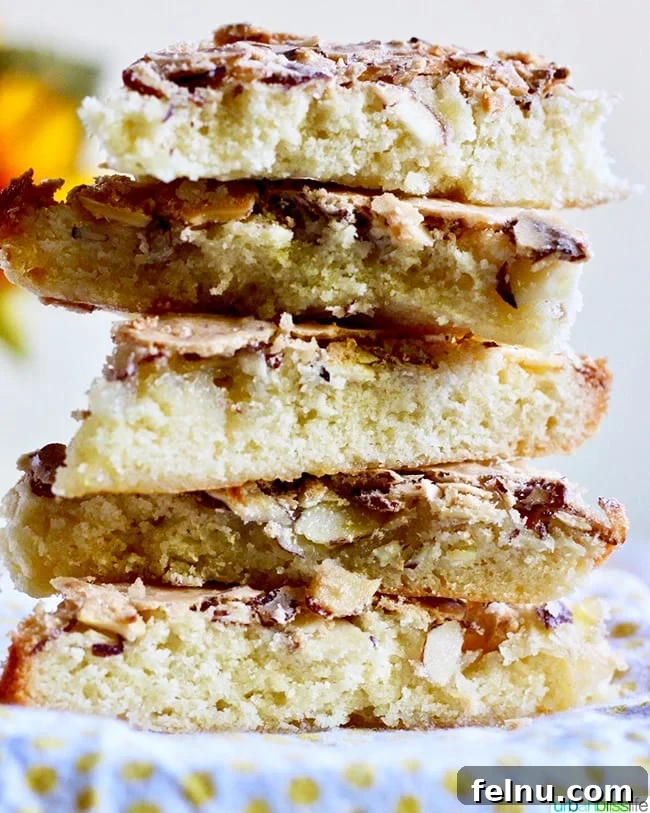Almond Swedish Visiting Cake Bars 3 A charming stack of triangular Swedish Visiting Cake Bars, highlighting their inviting texture and generous almond topping.