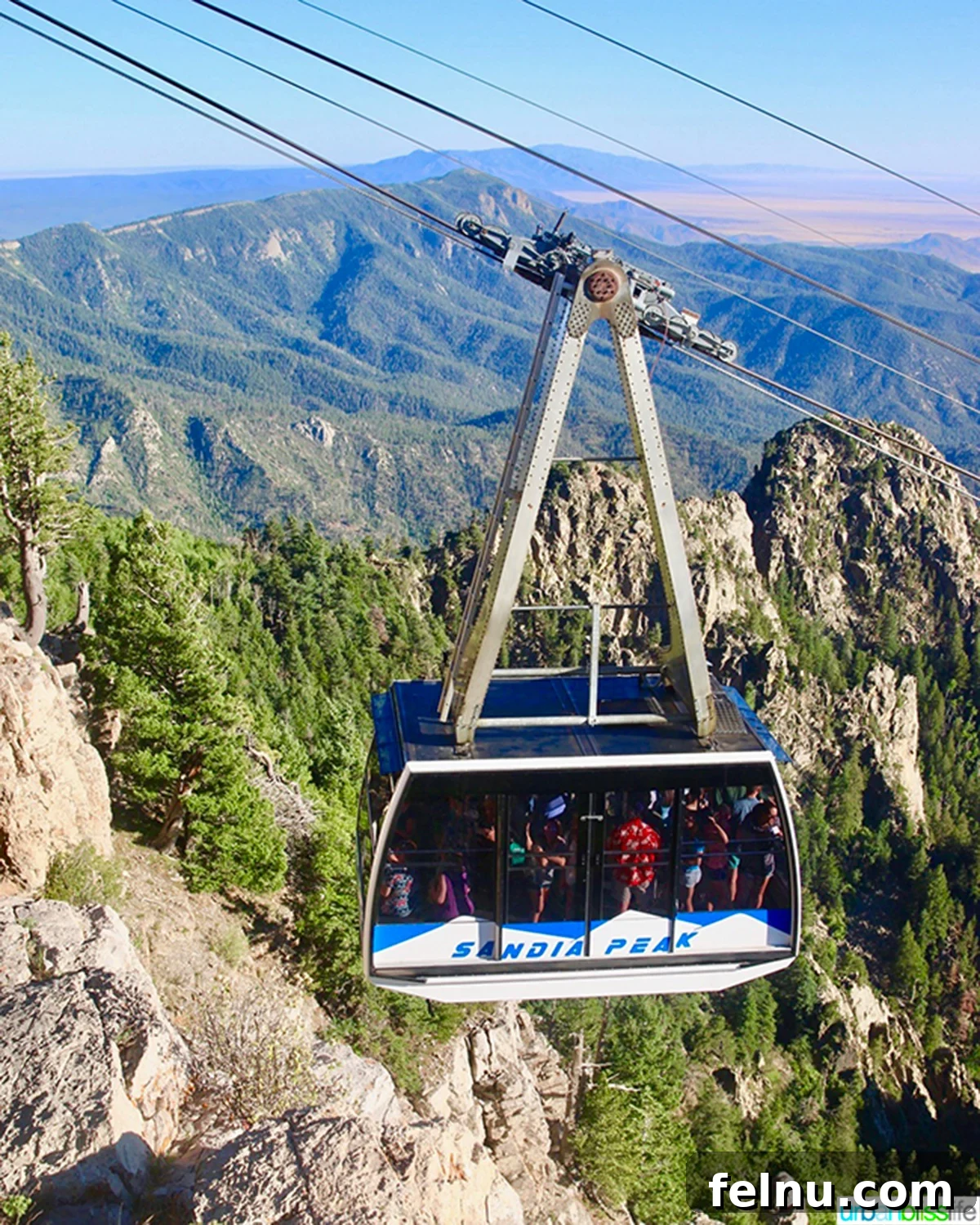 10 Albuquerque Gems You Must Explore 15 A cable car ascending the majestic Sandia Mountains in Albuquerque, New Mexico, against a dramatic sky