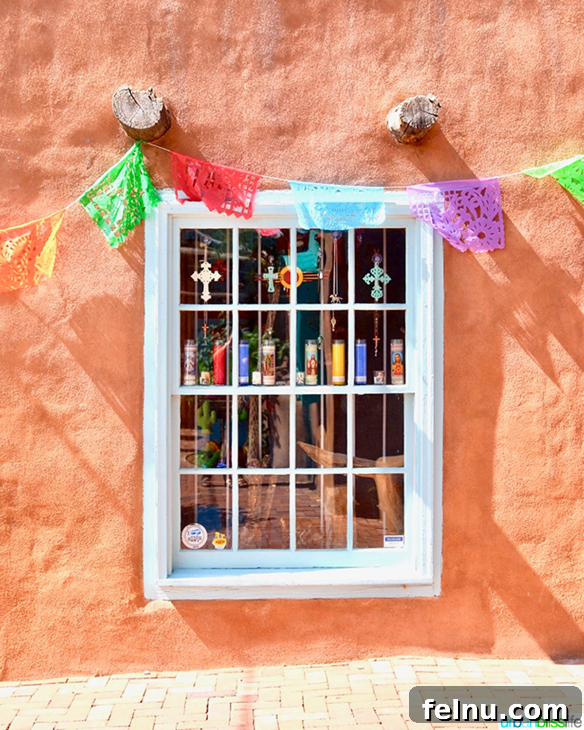 10 Albuquerque Gems You Must Explore 6 A vibrant, colorful window on an adobe building in Old Town Albuquerque