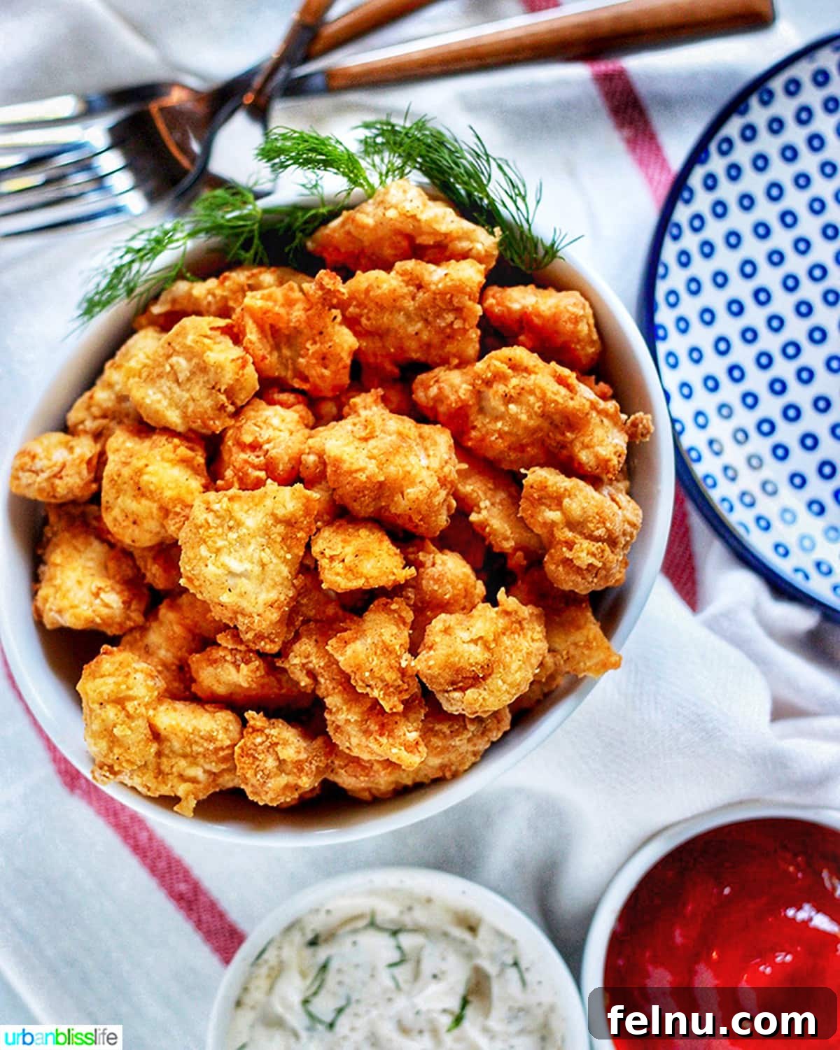 Air Fryer Popcorn Chicken Bites 7 Air Fryer Popcorn Chicken served with sauces and forks
