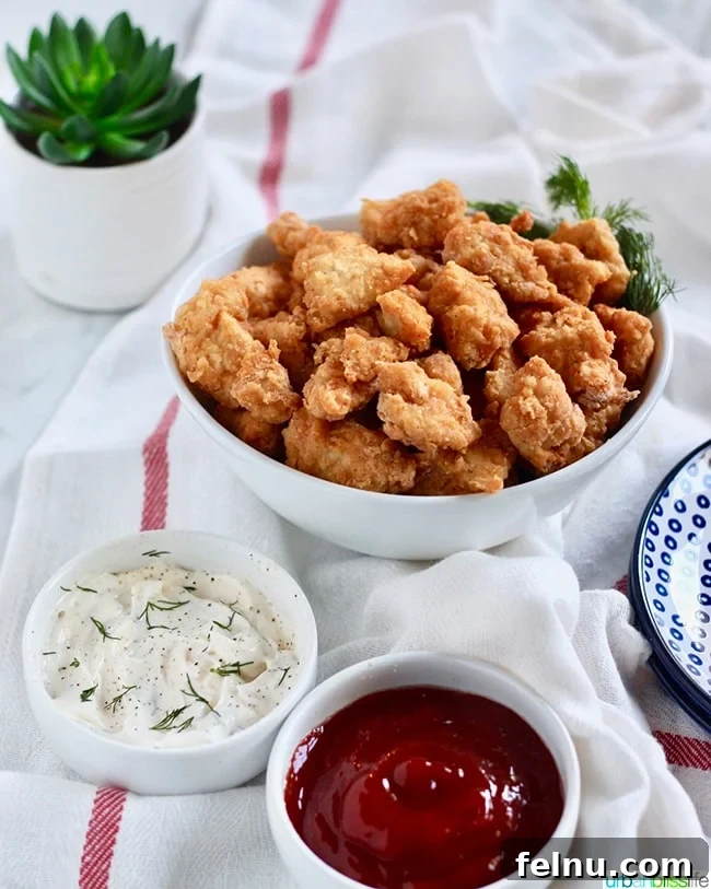 Air Fryer Popcorn Chicken Bites 9 Air Fryer Popcorn Chicken with dipping sauces and a plant