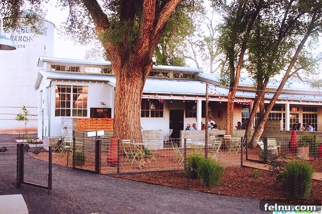 Experience Los Poblanos: Albuquerque's Historic Inn & Organic Farm 30 Campo restaurant at dusk, glowing warmly at Los Poblanos Inn