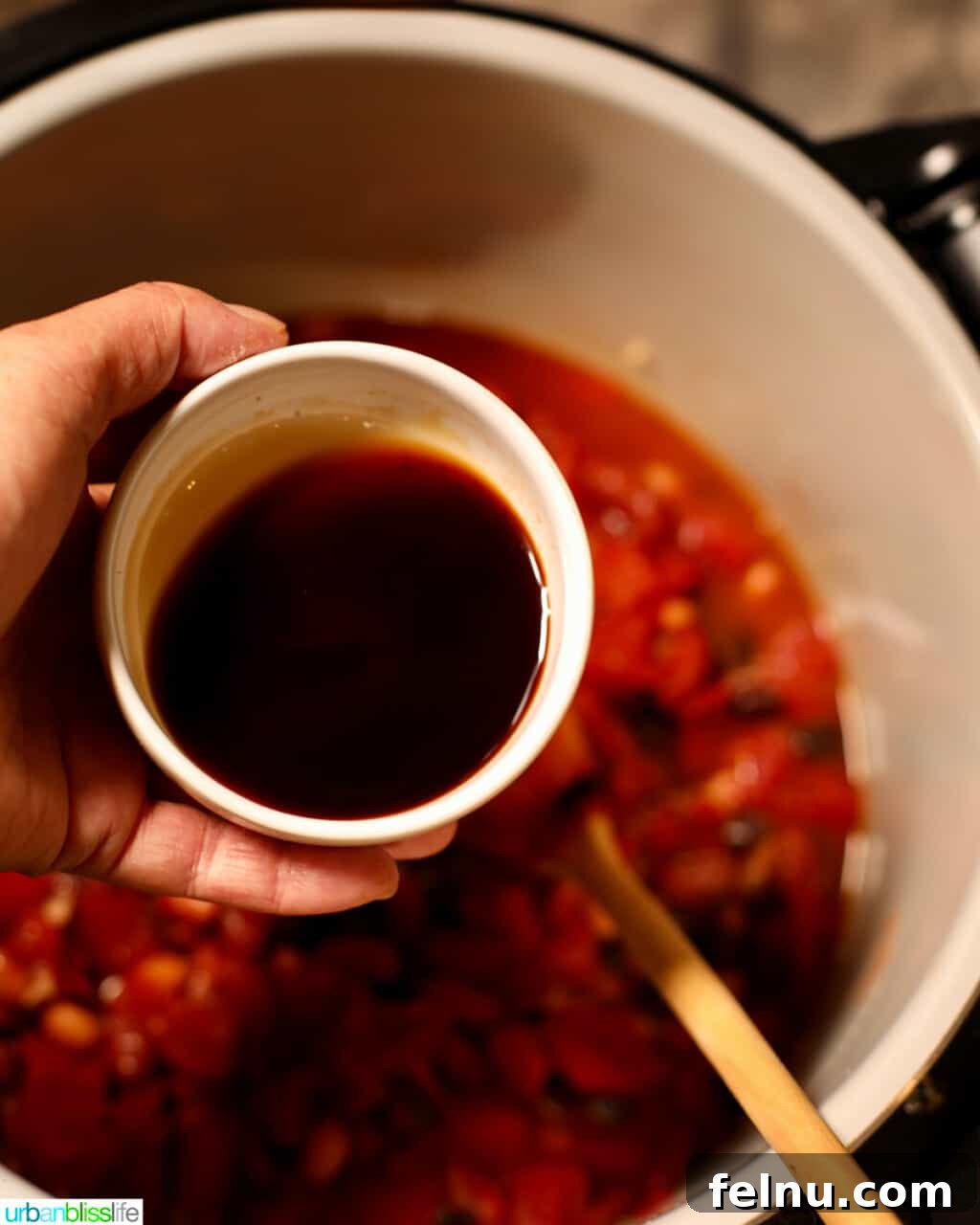 Hearty & Healthy Turkey Chili (Instant Pot Friendly!) 14 Adding Worcestershire sauce to the chili, enhancing the umami flavor.