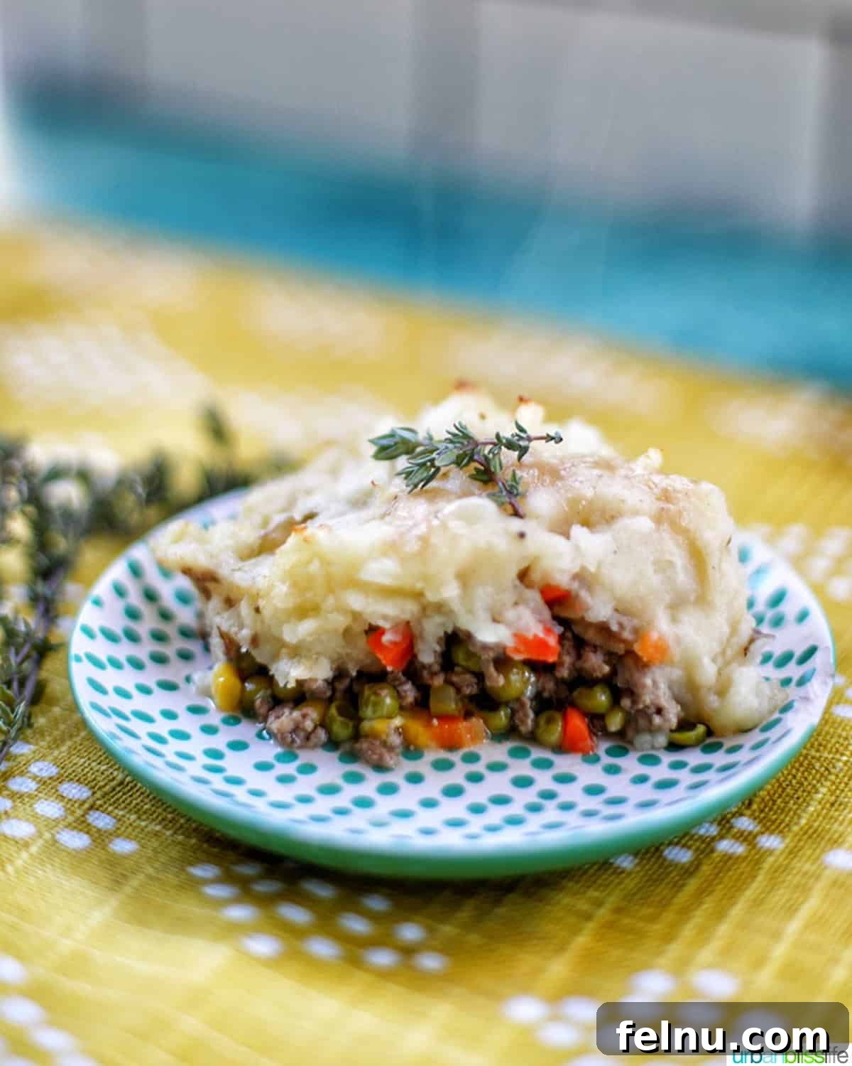 Hearty Dutch Oven Shepherd's Pie 2 A delicious slice of Shepherd's Pie served on a polka dot plate.