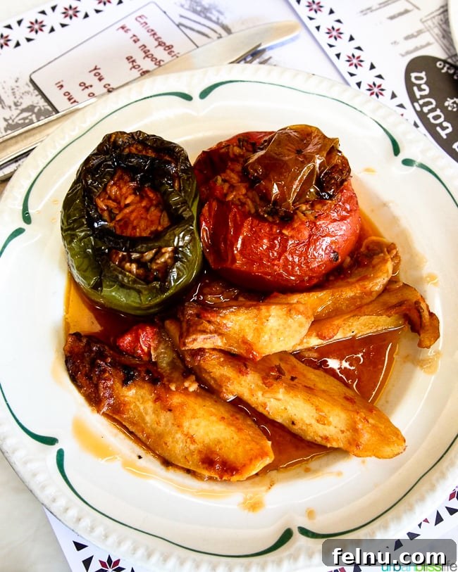 A hearty serving of stuffed tomatoes and peppers, a flavorful vegetarian option available at Dia Tafta