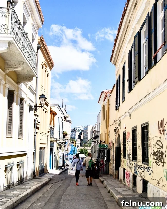 A picturesque old town street in the Plaka neighborhood of Athens, Greece, filled with charming shops and cafes