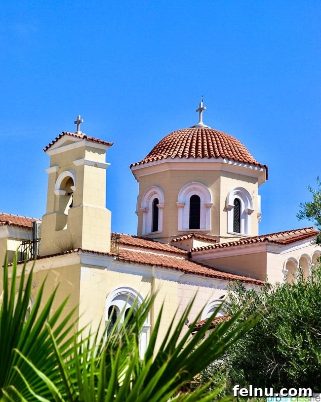 A charming yellow church nestled in the heart of the Plaka neighborhood of Athens, Greece