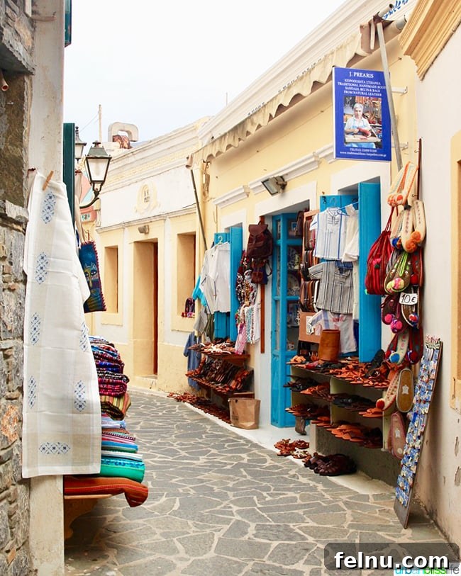 Greece Travel: Discover Olympos Village, Karpathos 12 A quaint side street with a shop selling shoes and bags in Olympos, Karpathos
