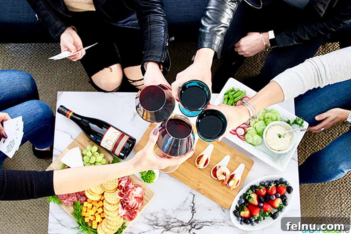 Unlock the Best Game Night Ever 2 Four women leaning in to cheers with glasses of wine over a table with charcuterie boards and holding game cards.