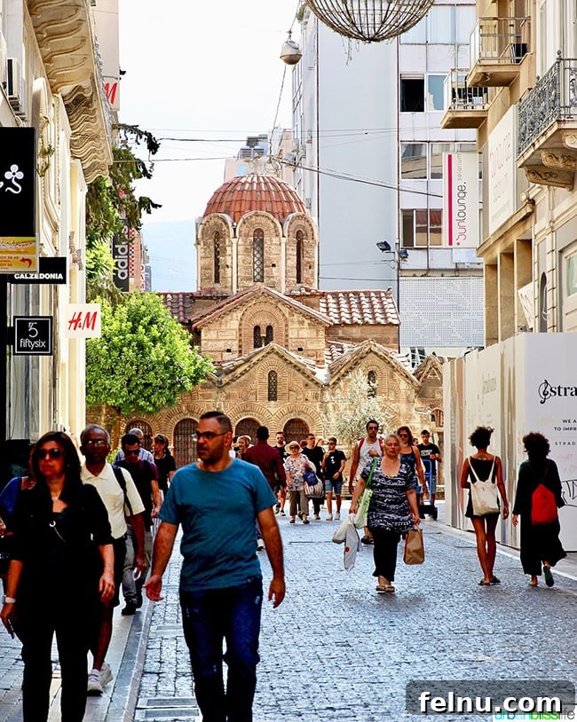Athens street scene with the Church of Panagia Kapnikarea in the background