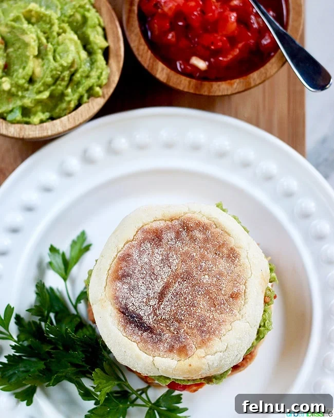 Rancheros Egg Stack 3 Top view of a mouthwatering Huevos Rancheros Breakfast Sandwich, showcasing its layers.