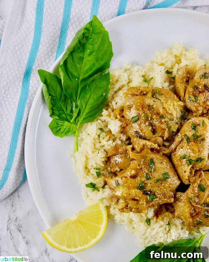 Zesty Instant Pot Lemon Garlic Chicken 3 Side shot of Instant Pot Lemon Garlic Chicken showing the juicy chicken and sauce.