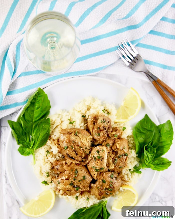 Zesty Instant Pot Lemon Garlic Chicken 8 Instant Pot Lemon Garlic Chicken served with a glass of white wine.