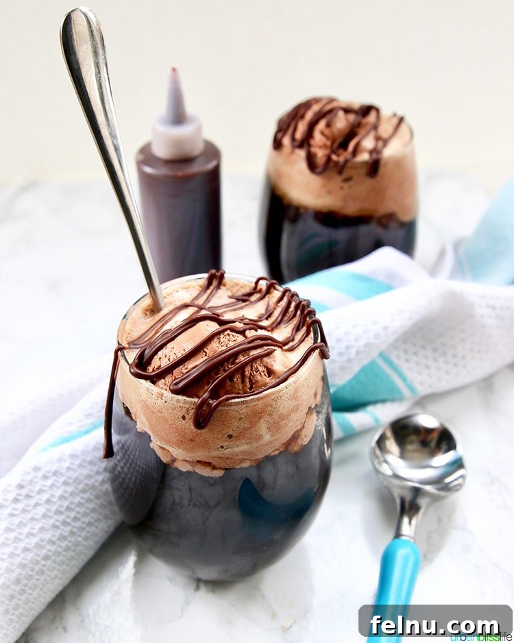 two Boozy Chocolate Peanut Butter Floats with syrup and scoop