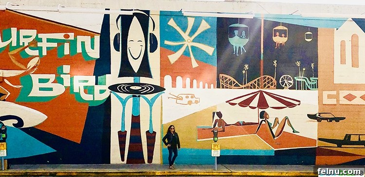 Surf, Sips, and City: San Jose to Livermore California Weekend 10 A colorful and whimsical mural depicting various elements of Santa Cruz culture and nature.