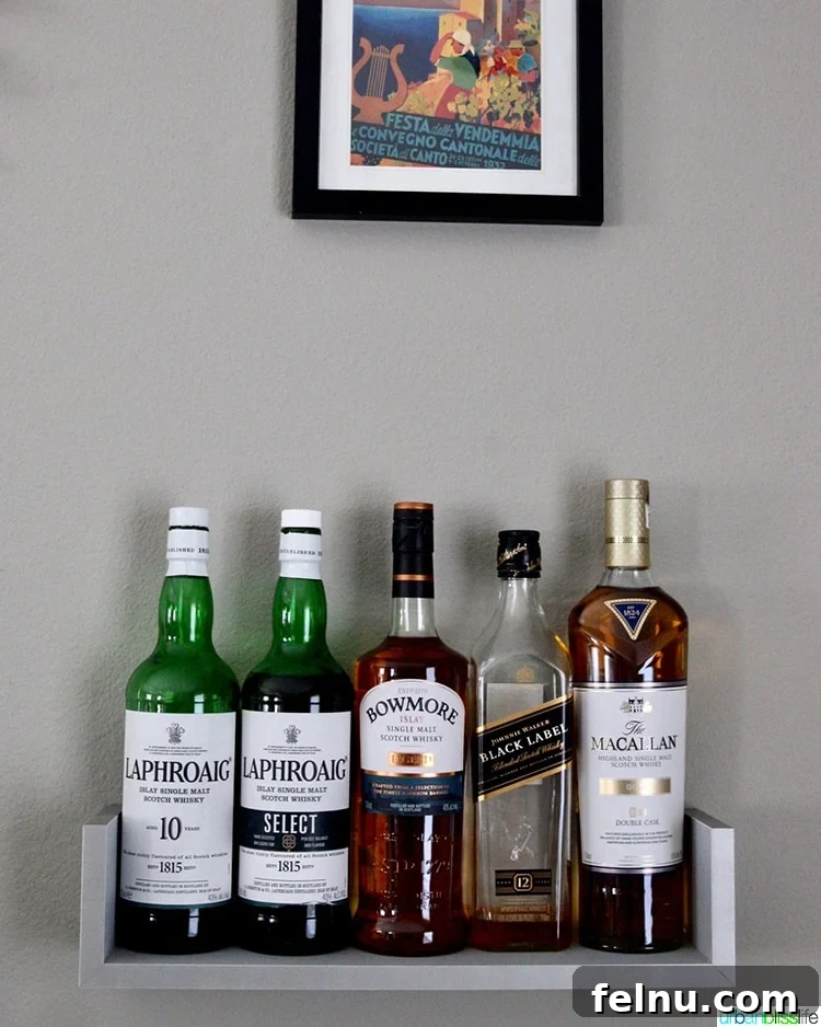 An assortment of whisky bottles on display in a home bar