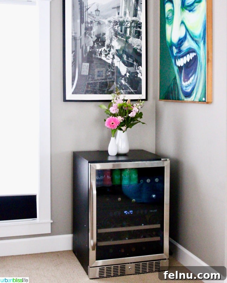 A beverage fridge storing wine and other drinks in a home bar setting