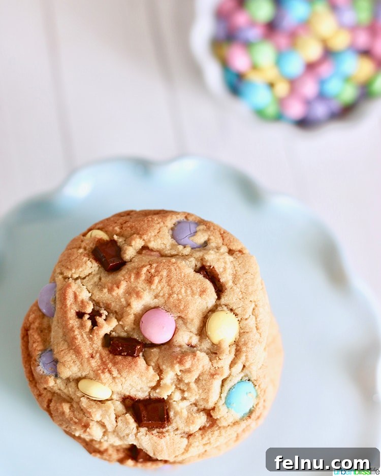 Colossal Chocolate Chunk Cookies 3 Overhead view of stacked Giant Chocolate Chip M&M Cookies, highlighting their size and the generous amount of M&Ms.