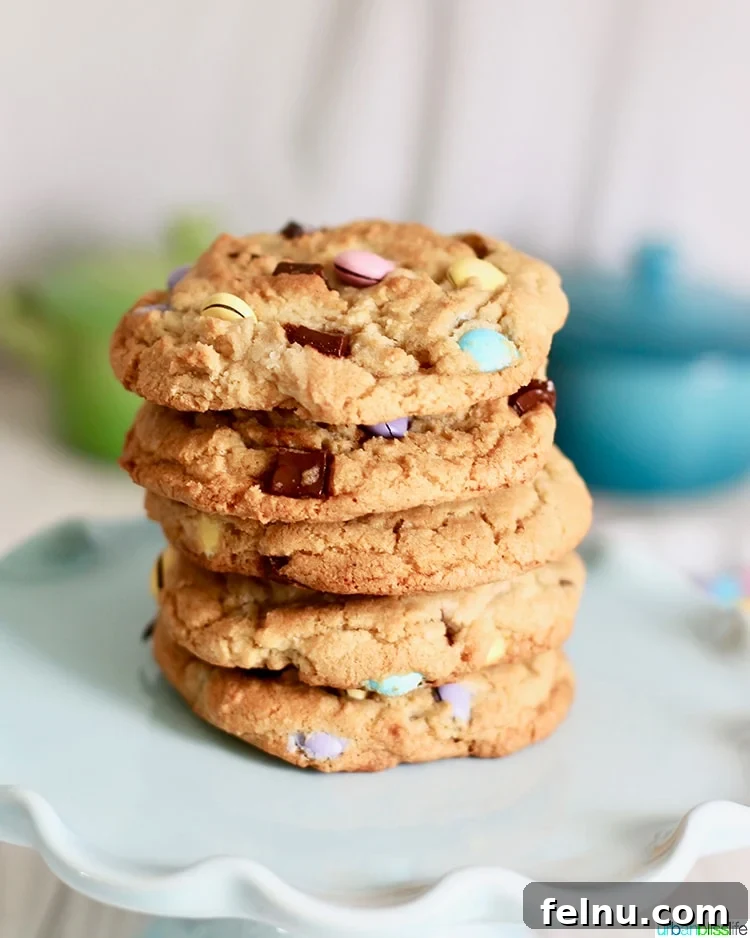 Colossal Chocolate Chunk Cookies 7 A stack of Giant Chocolate Chip M&M Cookies, emphasizing their soft texture and colorful appearance.